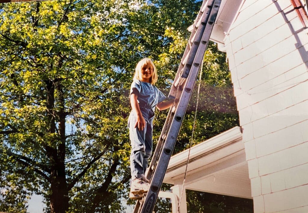 young girl on a ladder