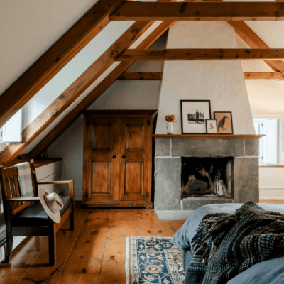 bedroom with tall, slanted ceiling and wooden beams