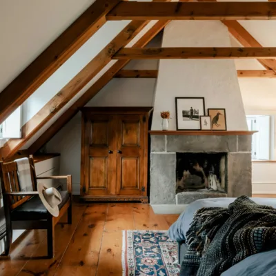 bedroom with tall, slanted ceiling and wooden beams