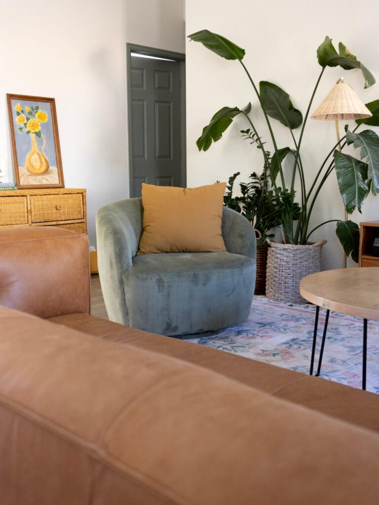 Green accent chair with mustard yellow accent pillow