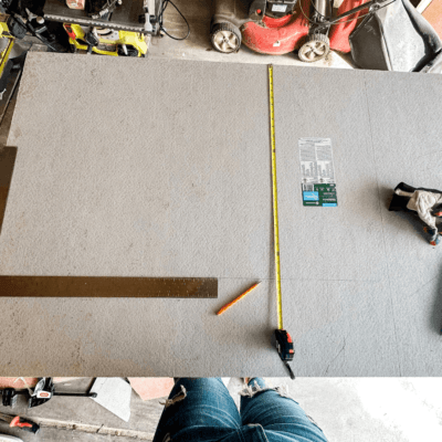 Cement backerboard with cutting and measuring tools on top