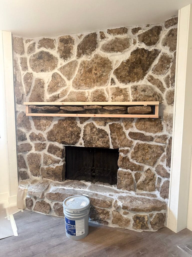 tan stone fireplace with white mortar in between the stones