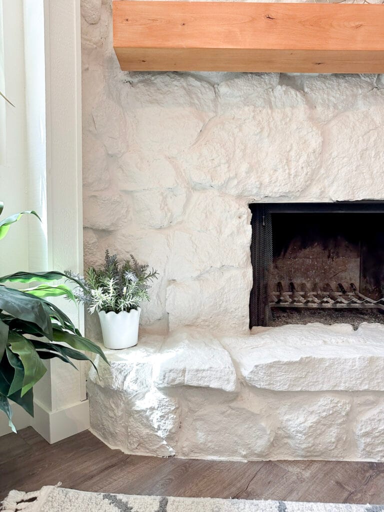 Close up of white painted stone fireplace hearth