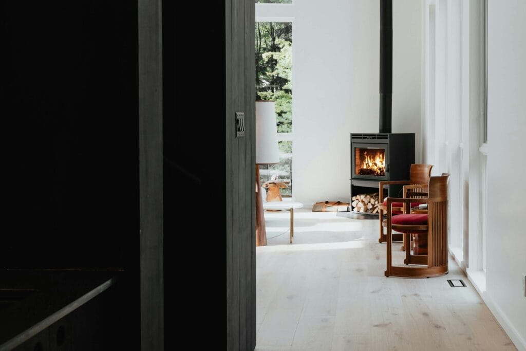 matte black industrial, minimal fireplace in white living room corner