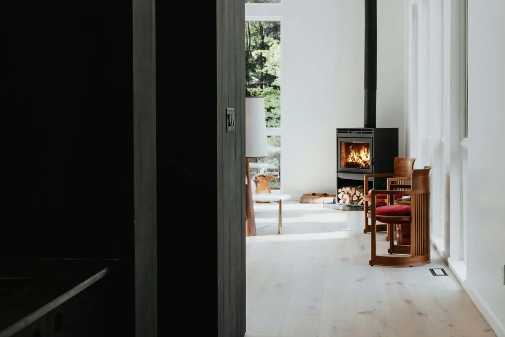 matte black industrial, minimal fireplace in white living room corner