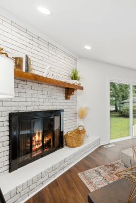 White painted brick corner fireplace