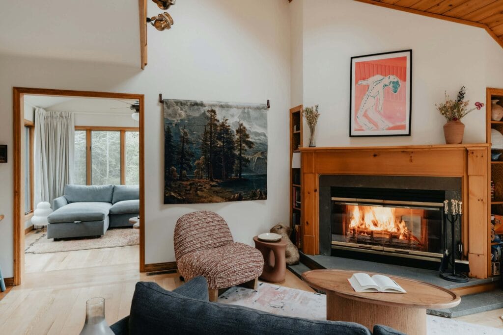 cabin living room with wood corner fireplace and modern furniture