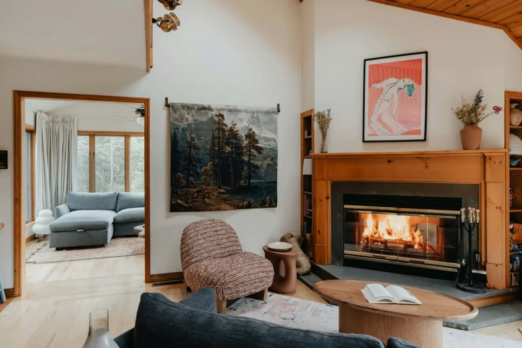 cabin living room with wood corner fireplace and modern furniture